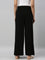 Women Solid Black Viscose Mid Rise Knit Palazzos