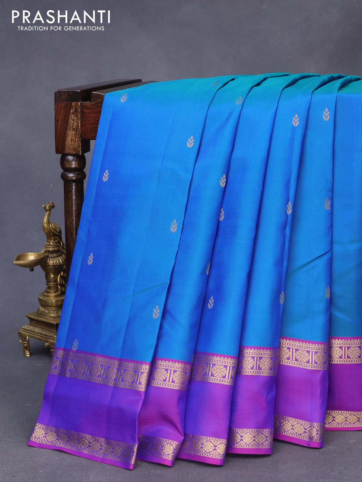 Pure kanchipuram silk saree dual shade of bluish green and purple with zari woven buttas and rettapet zari woven border