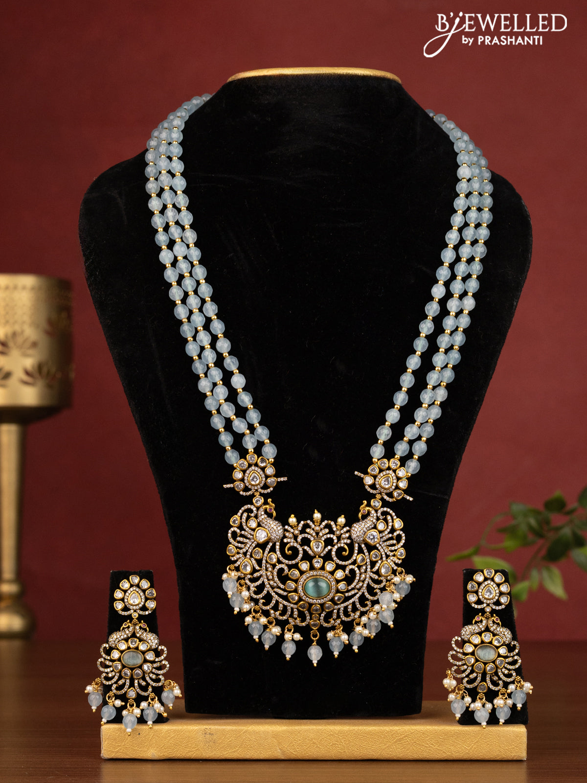 Beaded ice blue triple layer necklace peacock design with cz stones and beads hanging