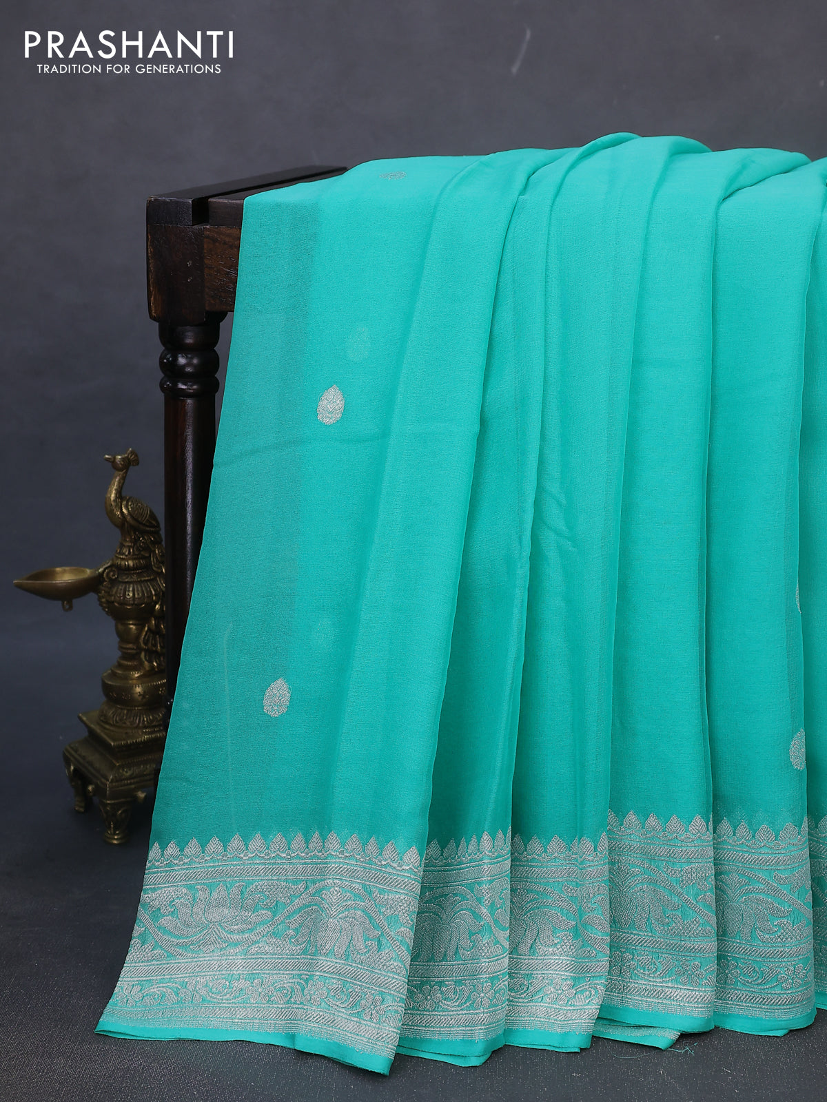 Banarasi chiffon silk saree teal green shade with silver zari woven buttas and silver zari woven border