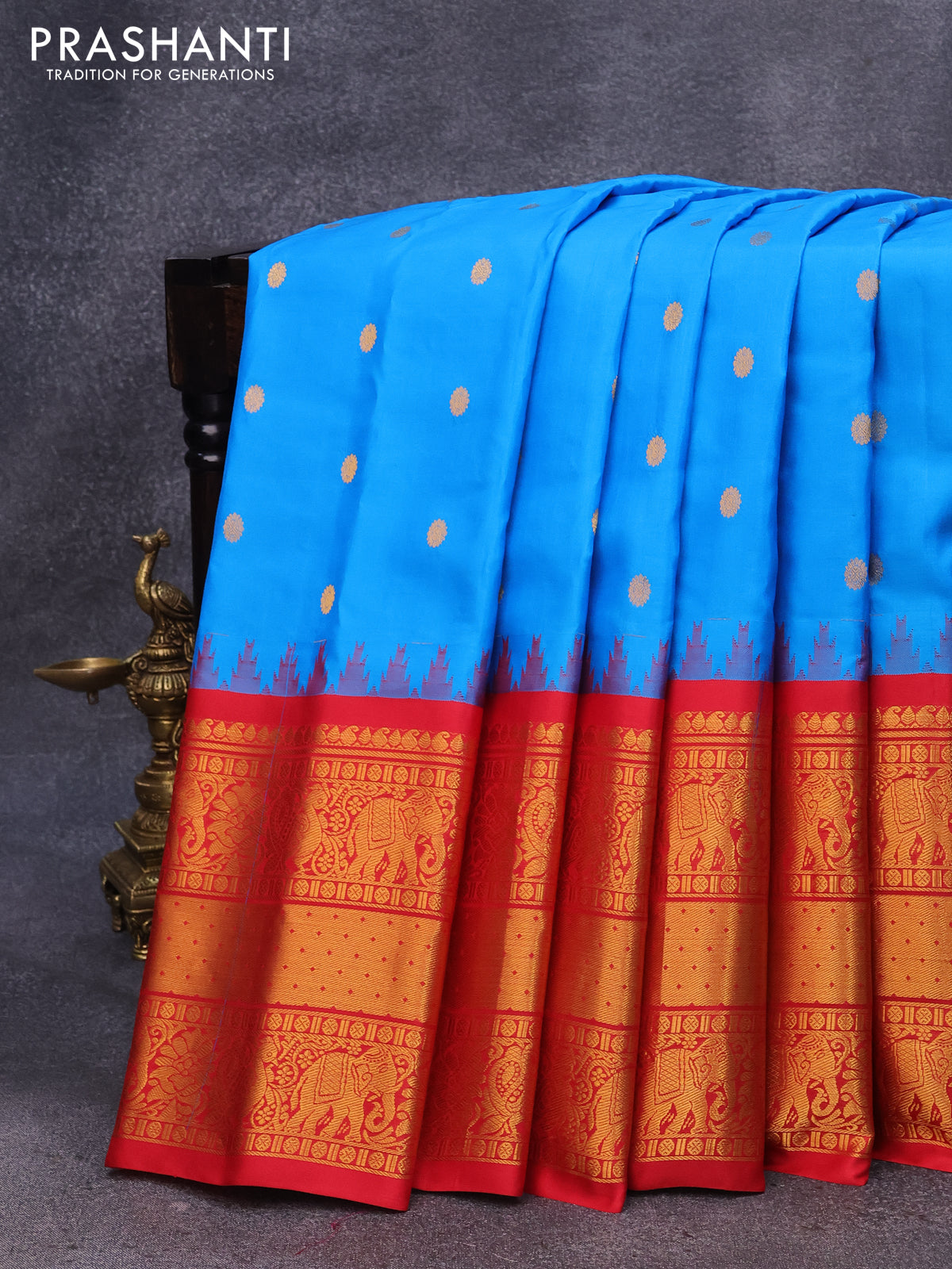 Pure gadwal silk saree cs blue and red with allover zari woven buttas and temple design long zari woven border