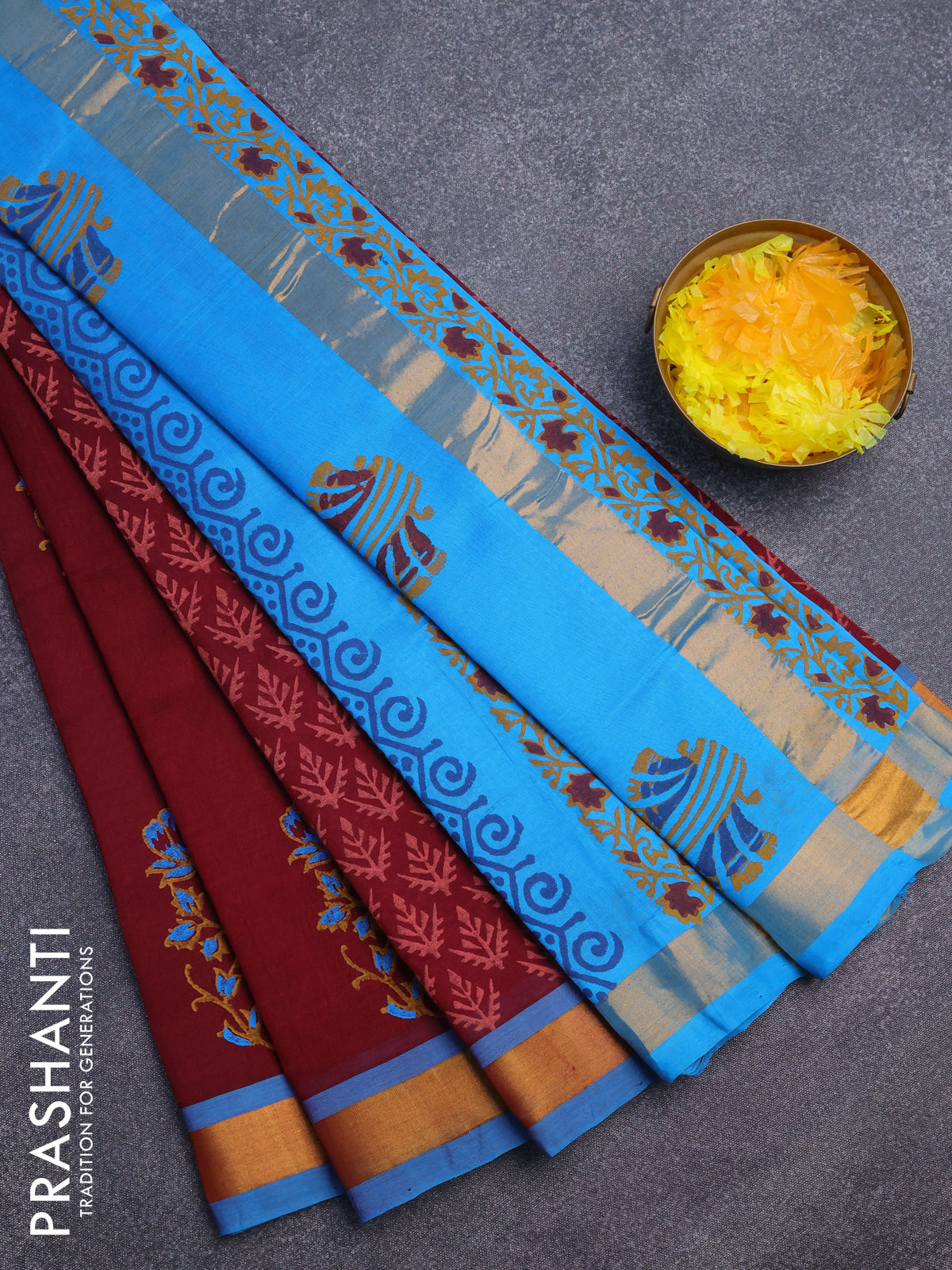 Silk cotton block printed saree maroon and cs blue with allover prints and zari woven border