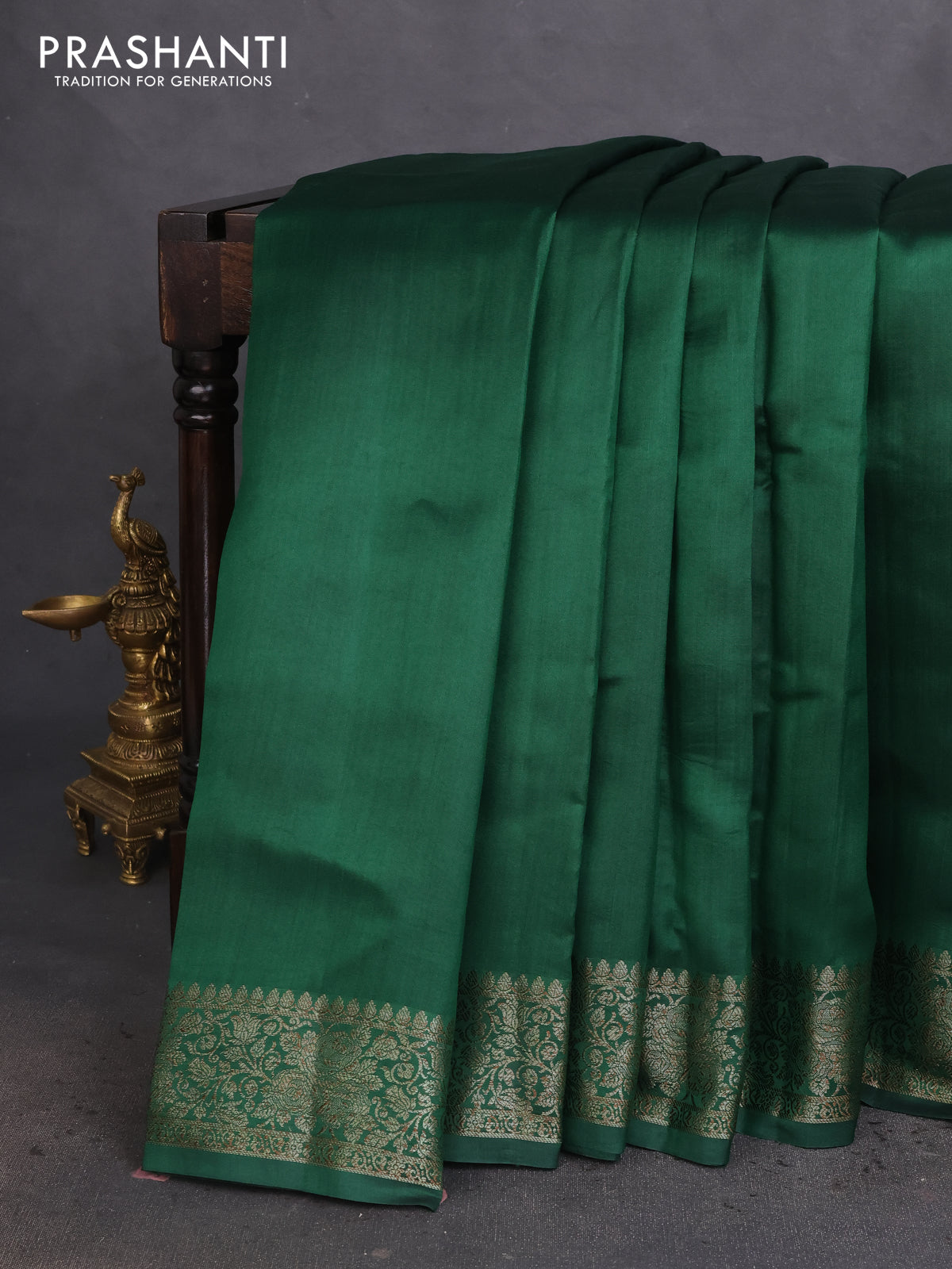 Chiniya silk saree dark green and rust shade with plain body and woven border
