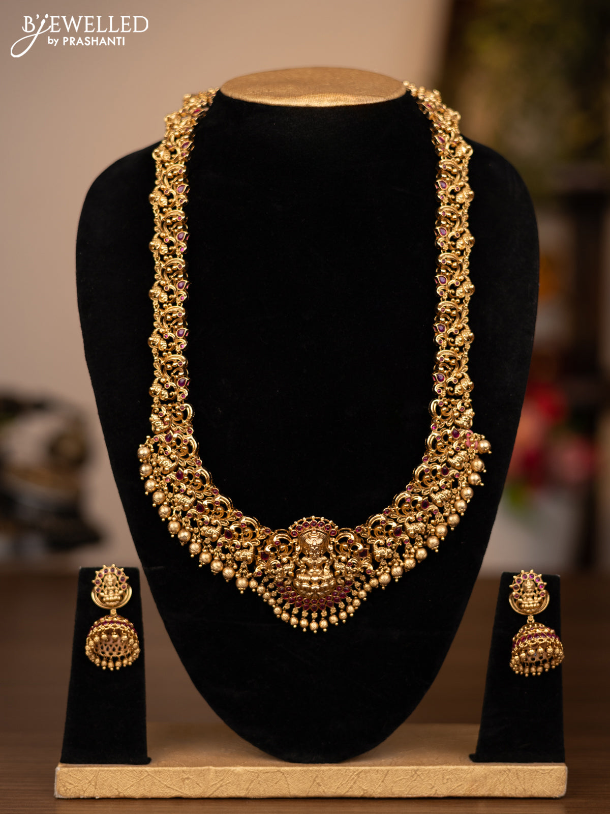 Antique haaram lakshmi design with pink kemp stones and golden beads hanging